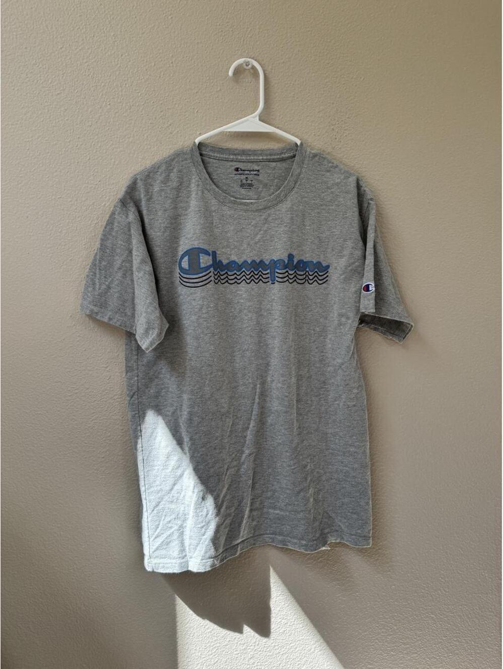 Gray Champion T-shirt with blue Champion logo with wavy lines